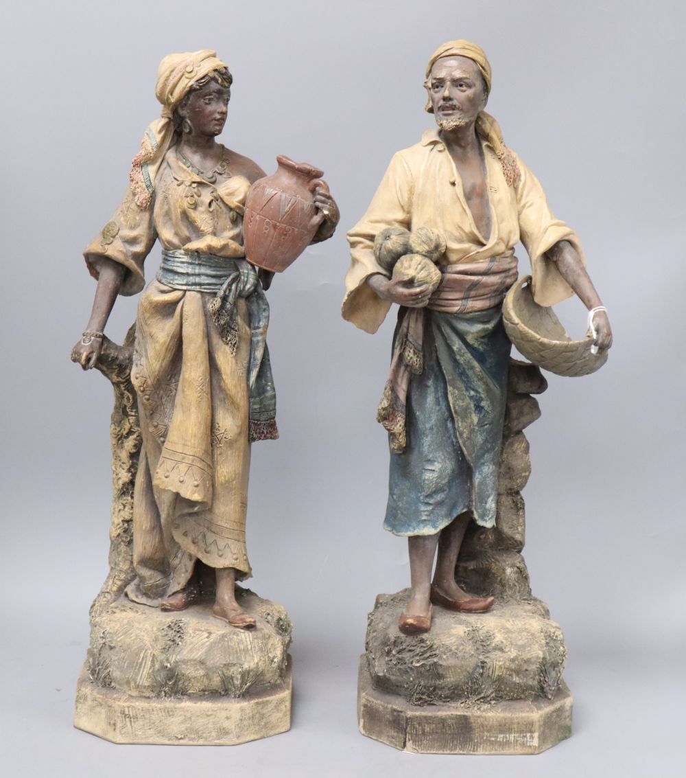 A pair of Austrian earthenware figures of street vendors, by Johann Maresch, height 48cm